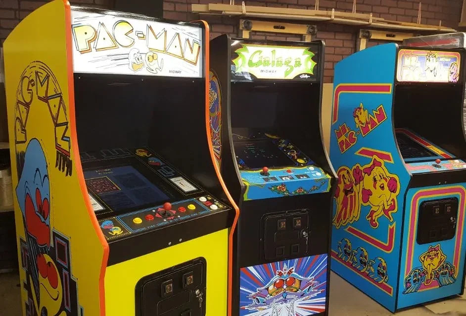 Classic 80s arcade games Galaga and Pac-Man running on a modern living room 4K TV with wireless controllers