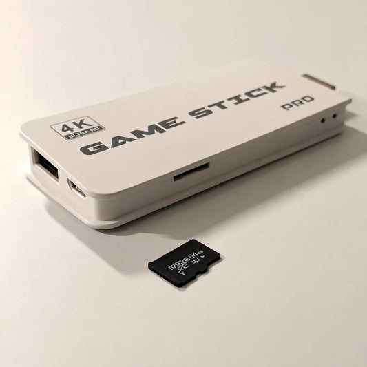 White 4K Ultra HD Game Stick Pro HDMI console showing its side TF card slot next to a 64GB microSDXC memory card