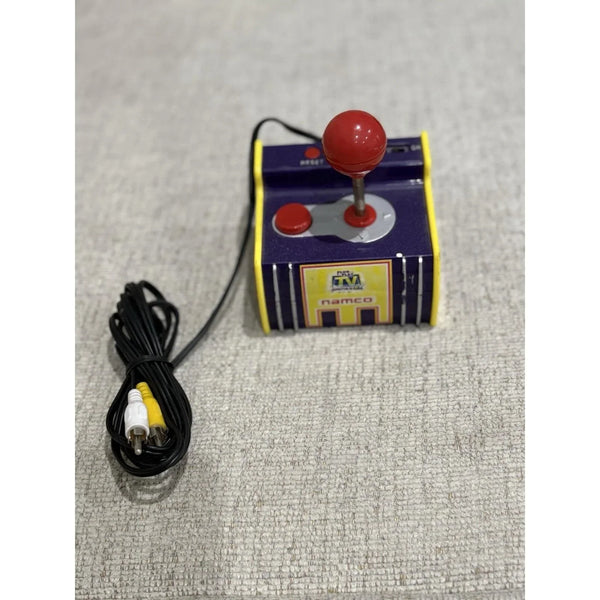 Yellow and black Jakks Pacific Pac-Man plug and play TV game joystick with yellow and white composite RCA plugs