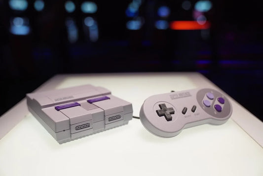 Nintendo SNES Classic Edition compared with 2Bluebox Retro Game Stick 4K Pro and wireless controllers on a TV stand