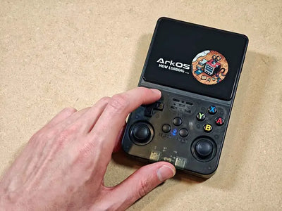 Bench-verified 2BlueBox R36S handheld console booting ArkOS 2.0 on its 3.5-inch IPS screen