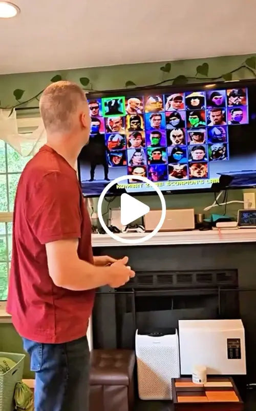 Man is playing Mortal Kombat 4 by 2Bluebox Retro Game Console