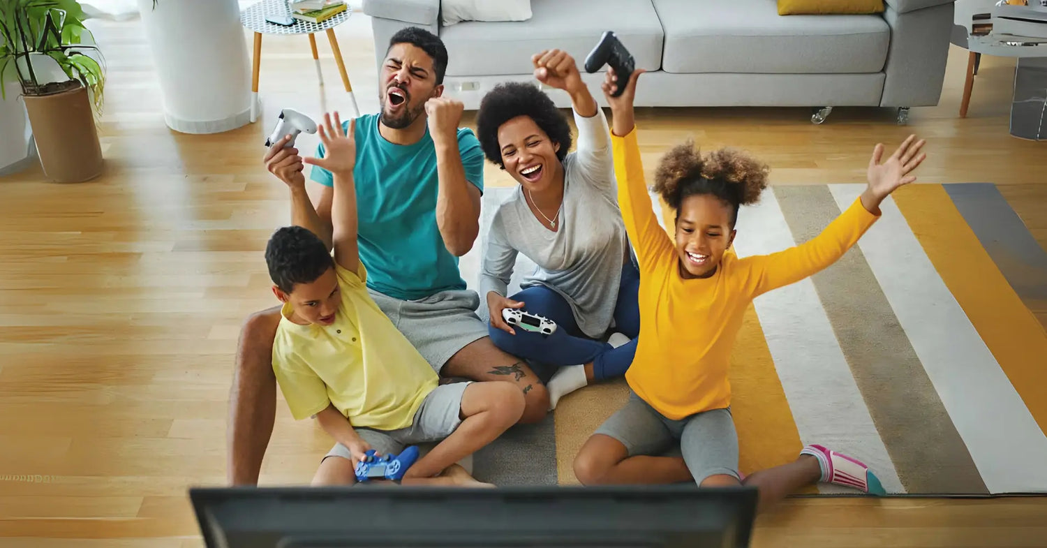 Family playing video games together with 2Blebox Retro Game Console in a living room