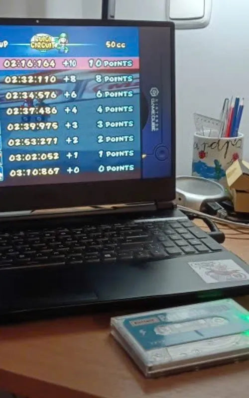 Portable HDD Super Console running Mario Kart Double Dash on a standard laptop with transparent case visible.